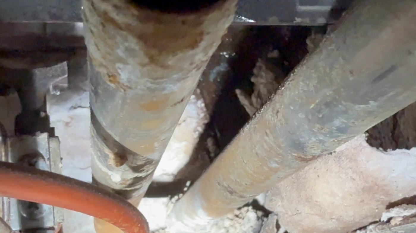 Video of a leaking joint on the near-boiler piping of a steam heating system