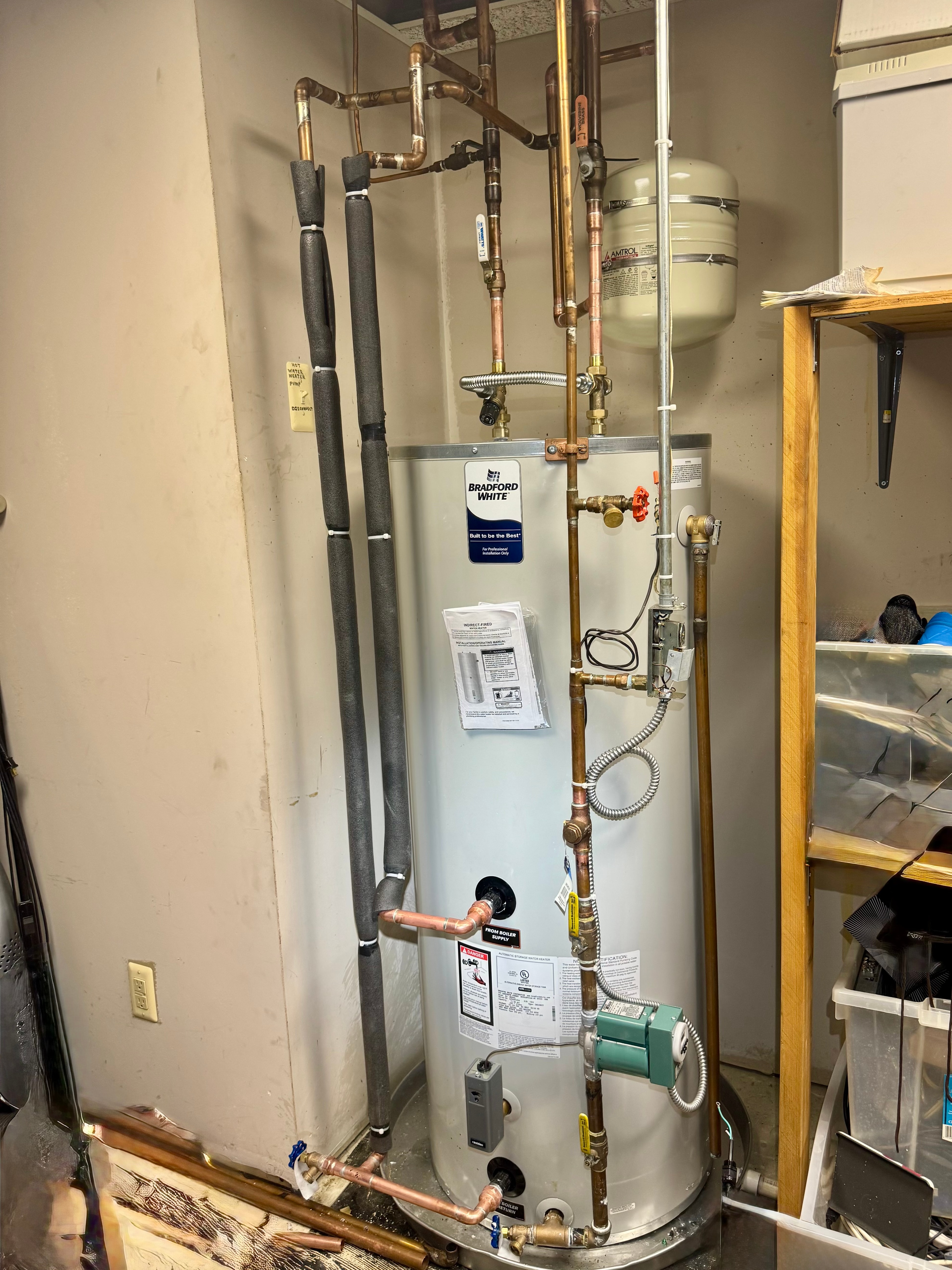 An indirect-fired Bradford White storage tank piped to a boiler, with expansion tank and circulator